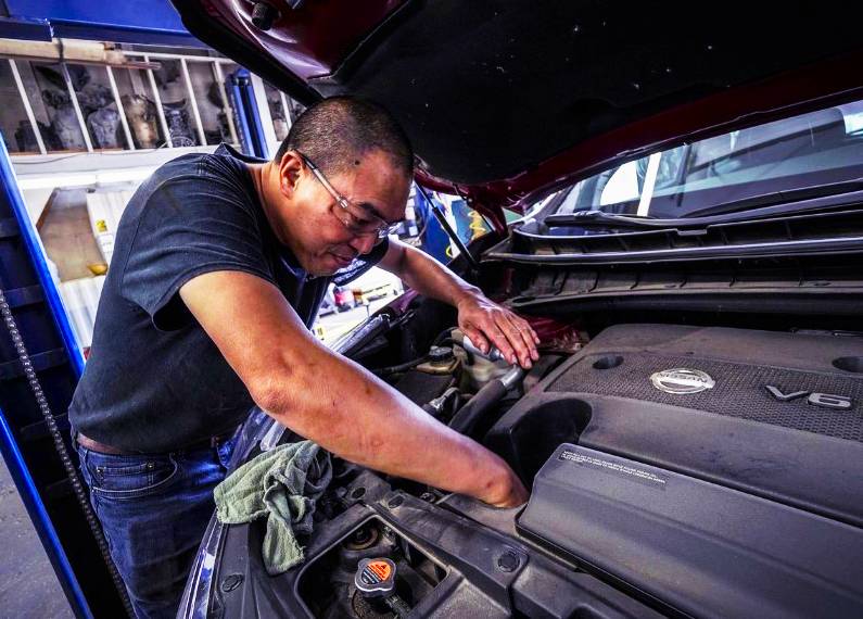 Automotive business owner reviewing organized financial reports